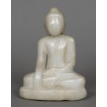 A Chinese carved alabaster figure of Buddha Typically modelled seated. 21 cm high.