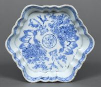 A Chinese Export blue and white dish Of crimped hexagonal form, decorated with floral sprays.
