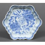 A Chinese Export blue and white dish Of crimped hexagonal form, decorated with floral sprays.