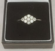 An 18 ct white gold diamond set ring The stones cluster set.