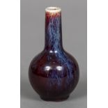 A small Chinese flambe glazed vase With elongated neck above the ovoid body,