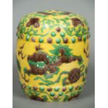 A small Chinese yellow ground barrel form seat Decorated in the round with trailing foliage and