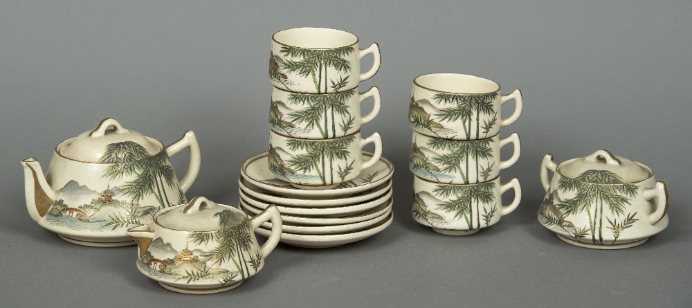 A fifteen piece Satsuma tea set Decorated with mountainous landscapes and bamboo fronds,
