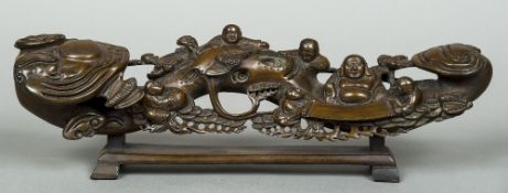 A Chinese carved wooden ruyi sceptre Decorated with Buddha reading to children from a scroll,