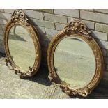 A pair of Victorian gilt framed girandole Each of oval form with pierced crestings and twin candle