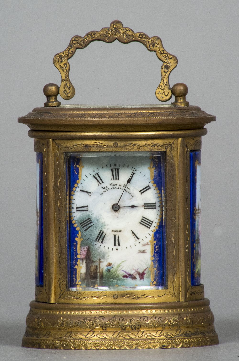 A late 19th century miniature oval gilt brass carriage clock Decorated with Sevres style painted