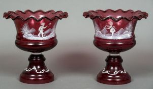 A pair of Mary Gregory cranberry glass pedestal bowls Each with wavy rim and decorated with a child