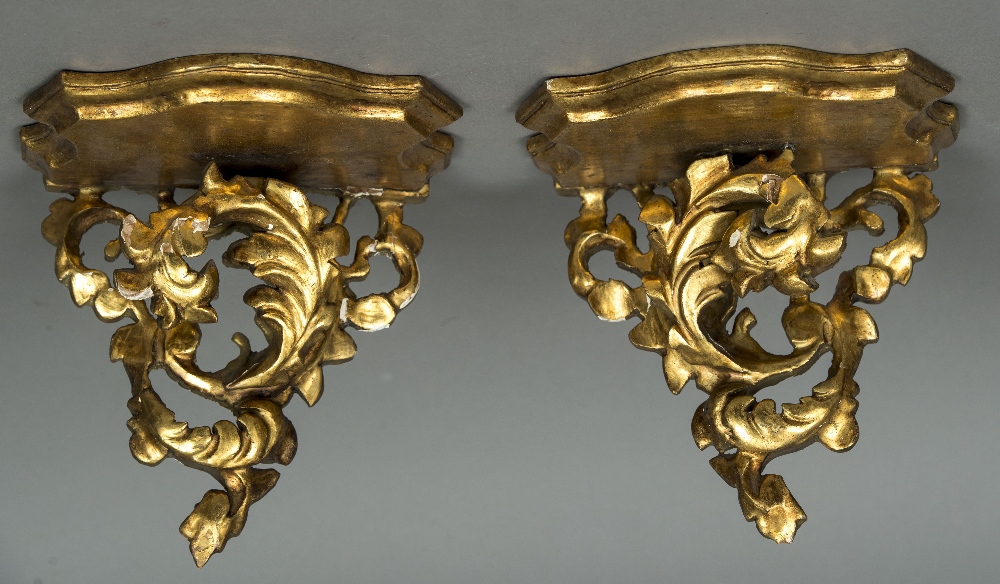 A pair of giltwood wall brackets Each with shaped shelf supported on an acanthus scroll.