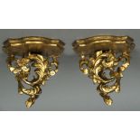 A pair of giltwood wall brackets Each with shaped shelf supported on an acanthus scroll.