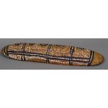 An Australian Aboriginal shield Of domed oval form with typical painted decorations. 73 cm long.