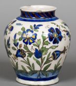 A Qajar pottery vase Of ovoid form, decorated with flowering blooms. 18 cm high.