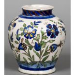 A Qajar pottery vase Of ovoid form, decorated with flowering blooms. 18 cm high.