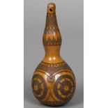 A carved double gourd Decorated with geometric decorations, the top with pierced suspension hole.