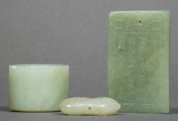 A Chinese carved celadon jade archers ring together with a carved celadon jade pendant