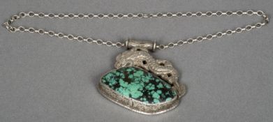 A large Chinese unmarked silver and matrix turquoise pendant Decorated with a dragon,