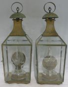 A pair of 19th century brass and copper framed hanging oil lamps Each with engraved glass panels.