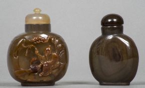 Two Chinese carved agate snuff bottles and stoppers The larger worked with a sage.