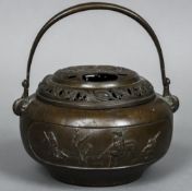 A 19th century Chinese bronze censor With swing loop handle above the pierced removable cover,