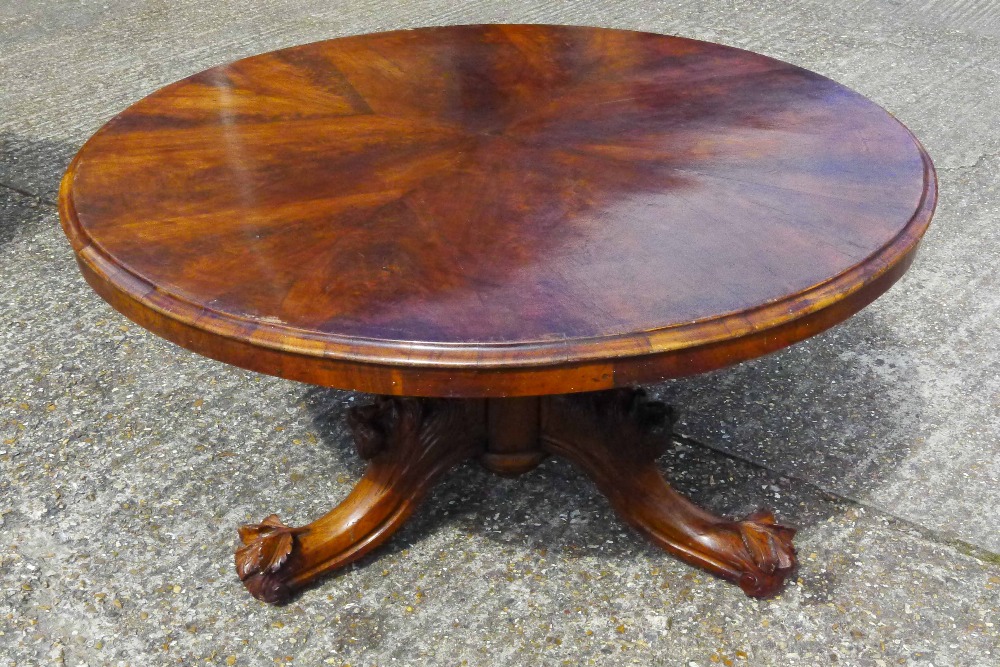 A Victorian mahogany top loo table The hinged circular top above the walnut base with bulbous