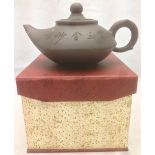 A Chinese Yixing pottery teapot and cover The body with incised decoration and calligraphic script,