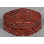 A late 19th/early 20th century Chinese cinnabar lacquered box and cover Of serpentine form,