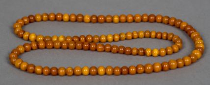 An amber bead necklace 45 cm long, the beads approximately 1 cm diameter.