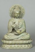 A soapstone figure of Buddha Typically modelled, seated in the lotus position, holding a small vase.