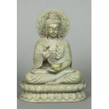 A soapstone figure of Buddha Typically modelled, seated in the lotus position, holding a small vase.