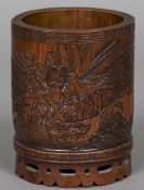 A late 19th century Chinese bamboo brush pot Carved with a warrior killing an eagle in a