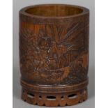 A late 19th century Chinese bamboo brush pot Carved with a warrior killing an eagle in a