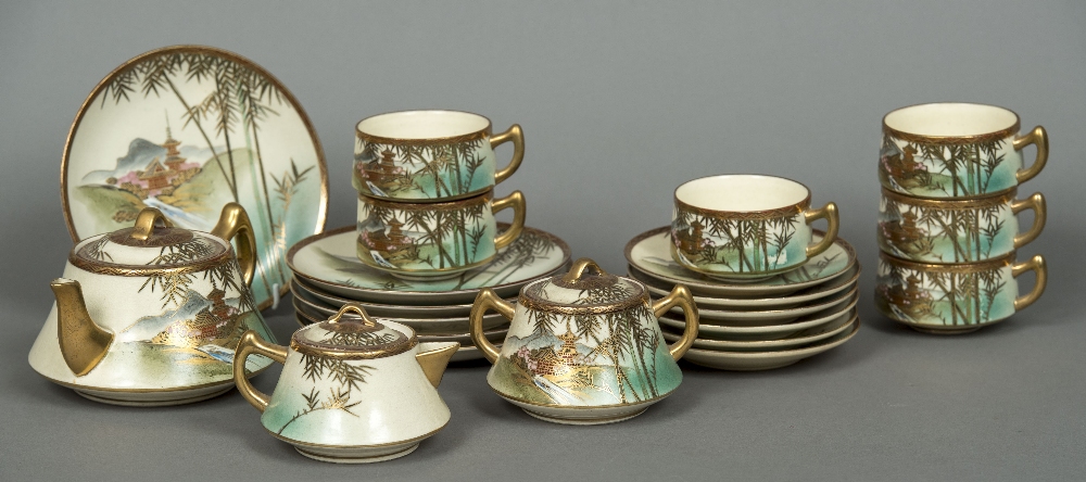 A twenty-one piece Satsuma tea set Decorated with pagodas amongst bamboo fronds.