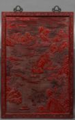 A large Chinese cinnabar lacquer plaque Extensively carved with figures in a mountainous river