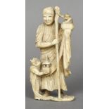 A 19th/20th century Japanese carved ivory group Worked as a sage attended by two imps. 14 cm high.