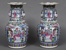 A pair of 19th century Canton famille rose vases Each with twin dog-of-fo handles and scrolling