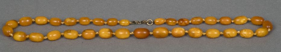 A butterscotch and amber bead necklace Together with a butterscotch amber pendant on 9 ct gold