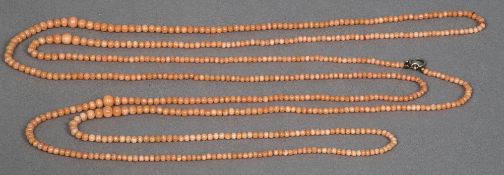 A red coral graduated bead necklace 109 cm long, the largest beads 8mm diameter.