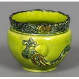 A 19th century Chinese green glazed bowl The florally decorated rim above the main body decorated