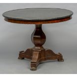 A 19th century marble topped mahogany tripod table The dished circular black variegated marble top