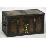 A 17th century iron and brass bound ships chest Of hinged rectangular form,
