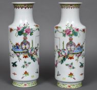 A pair of early 20th century Chinese porcelain rouleau vases Each painted with a flowering vase and