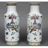 A pair of early 20th century Chinese porcelain rouleau vases Each painted with a flowering vase and