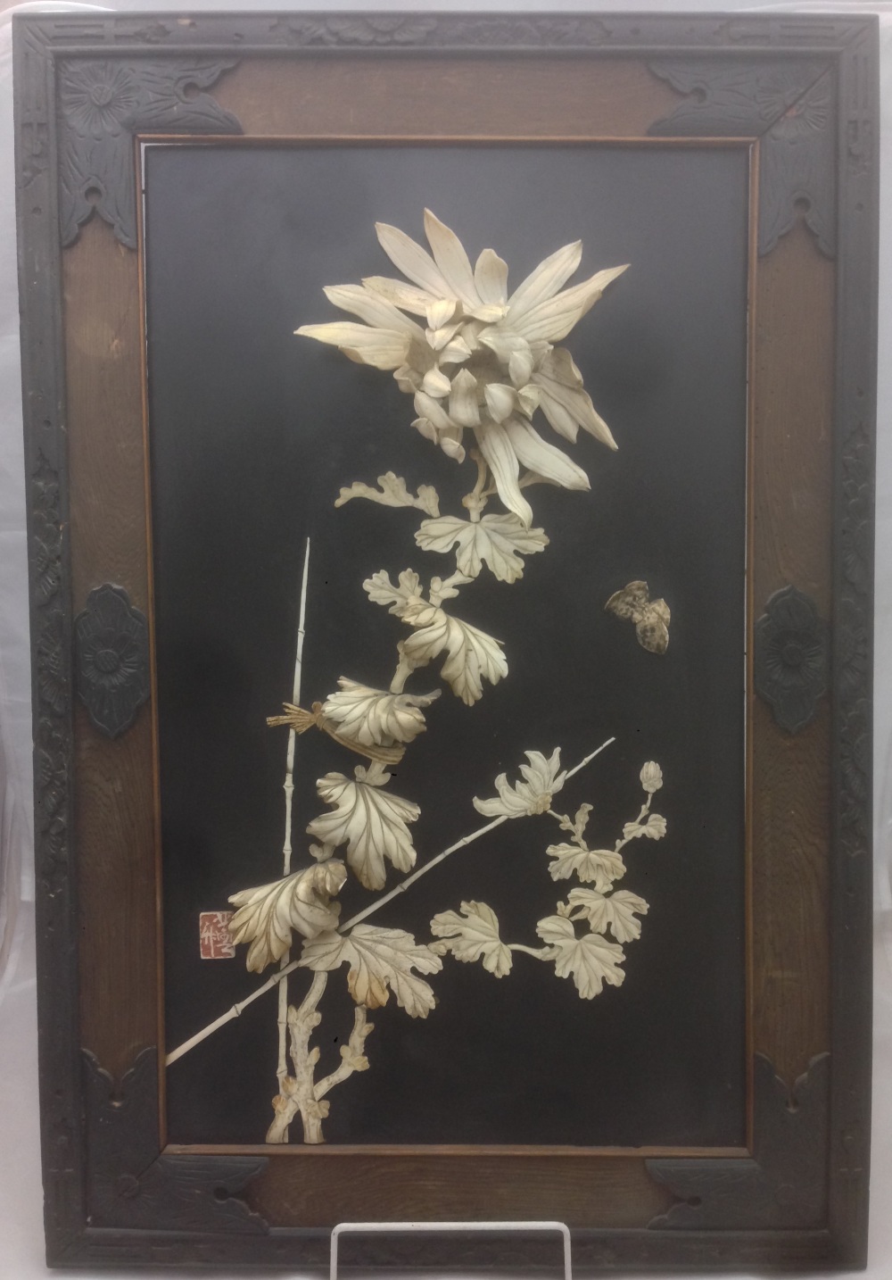 A pair of 19th century Japanese ivory and bone inlaid panels Each worked with insects and floral
