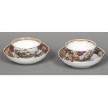 A pair of Chinese porcelain tea bowls and saucers Each decorated with figures on a terrace.