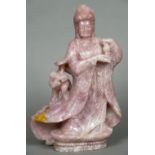 A large Chinese rose quartz carving of Guanyin Modelled standing in flowing robes with an attendant