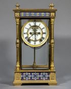 An American gilt metal and champleve enamelled four glass mantel clock The white dial with Roman