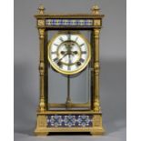 An American gilt metal and champleve enamelled four glass mantel clock The white dial with Roman
