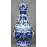 A Chinese blue and white porcelain altar vase Of baluster form with garlic head and applied flanges,