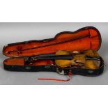 A 19th century violin With single piece back and lion carved stock; together with a bow,