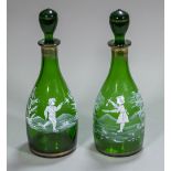 A pair of Victorian Mary Gregory green glass decanters and stoppers Each of mallet form and