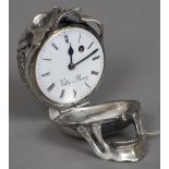 An unmarked silver desk clock Formed as a skull with pierced scrollwork and a cartouche,